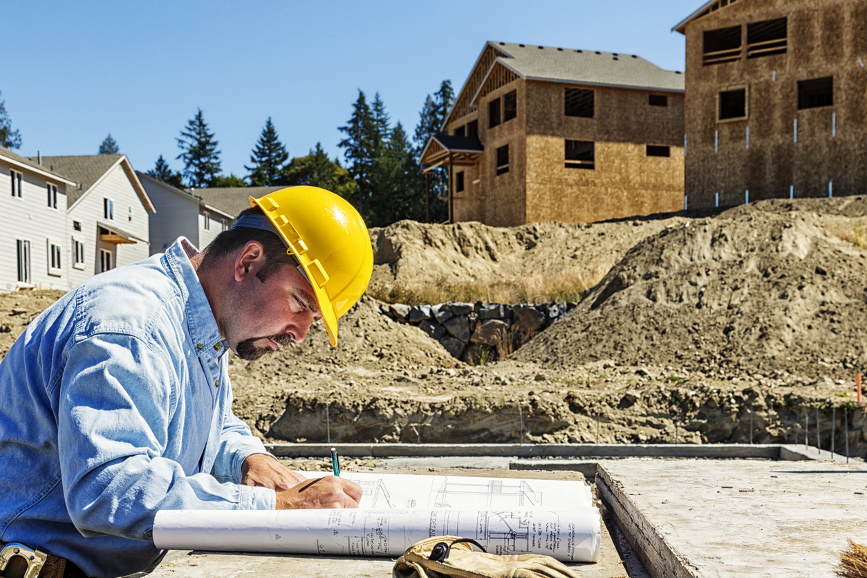 Construction Worker on Site with Plans