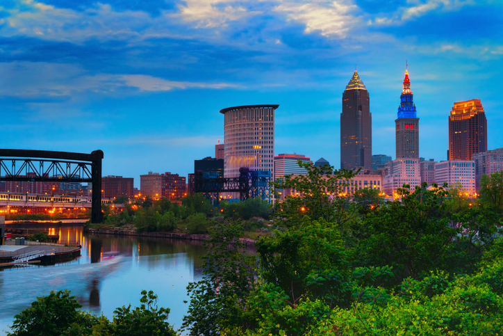 Downtown Cleveland beginning to light up at dusk wtih the Cuyahoga River winding past