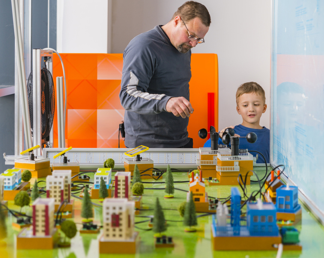 The father explaining the model of the city to his son, at the exhibition of the Hall of Science and Technology